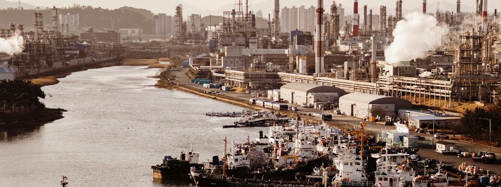 A working port with tanker berths and industrial plant behind it.